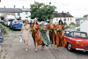 Bridesmaids and mother of the bride arriving at the church for wedding photography and videography