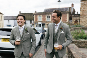 groomsmen walk to church wedding photography Devon Rustic farm family wedding in devon