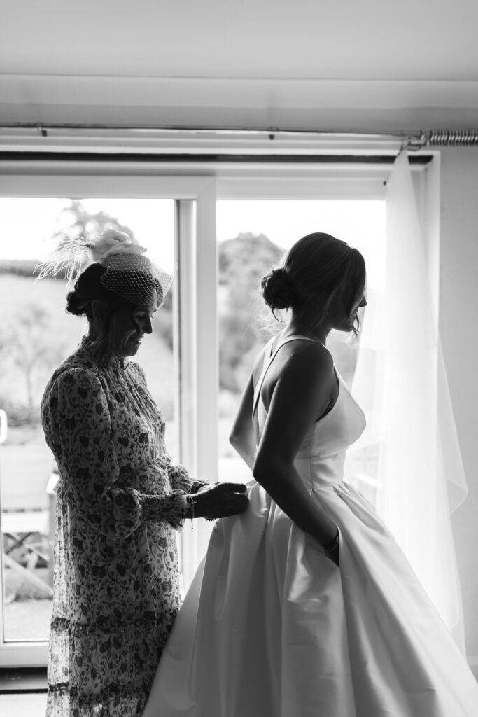 mother and daughter prepare for wedding black and white photo