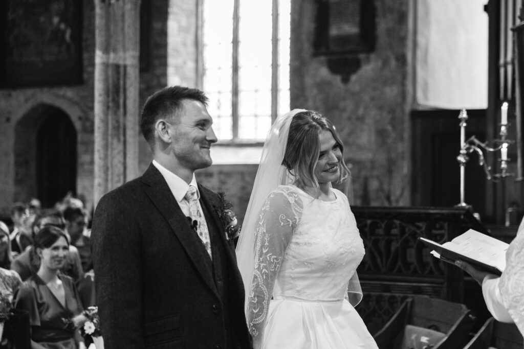 Groom and Bride meet eachother on the isle in black and white photography