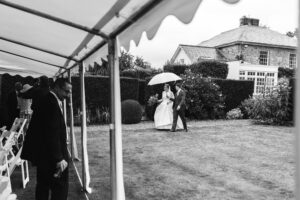 Bride and groom arrive to rustic and country wedding reception in Rustic farm family wedding in devon