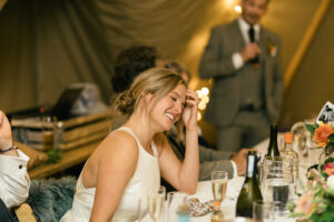 bride laughing and smiling photography candid moment Rustic farm family wedding in devon
