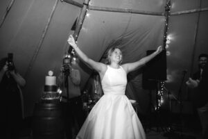 Bride on the dance floor during wedding inside marquee black and white photography and videography
