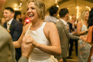 candid moment of bride on the dance floor