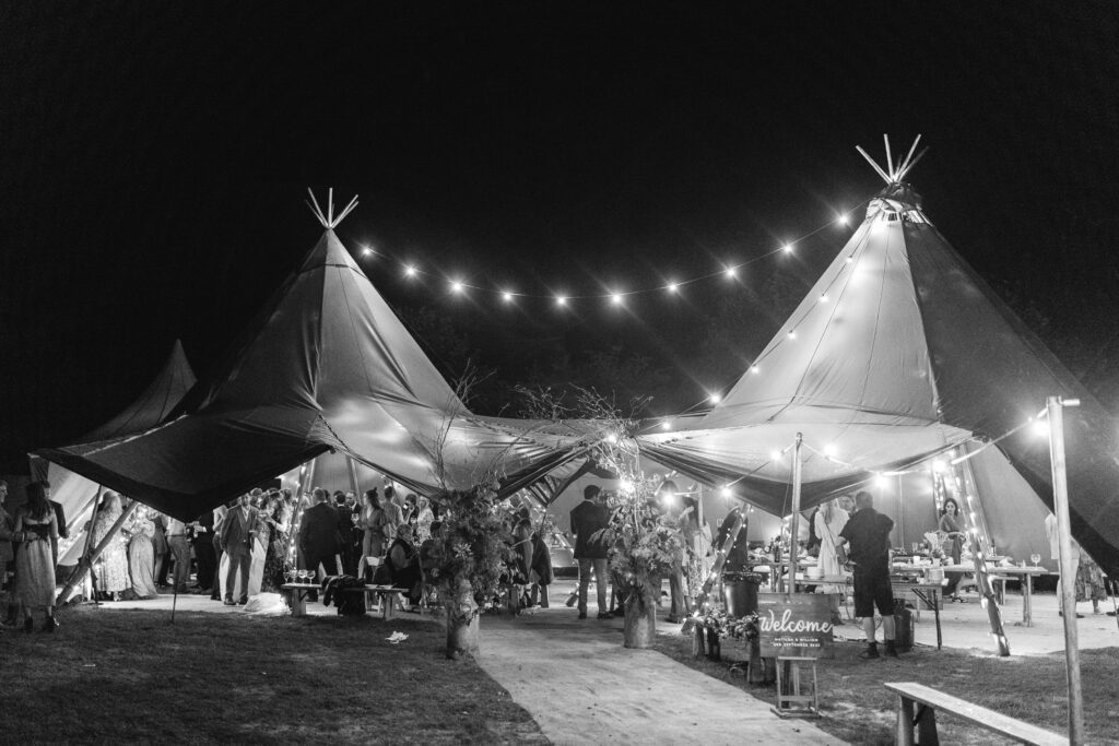Wedding marquee lit up with fairy lights Rustic farm family wedding in devon