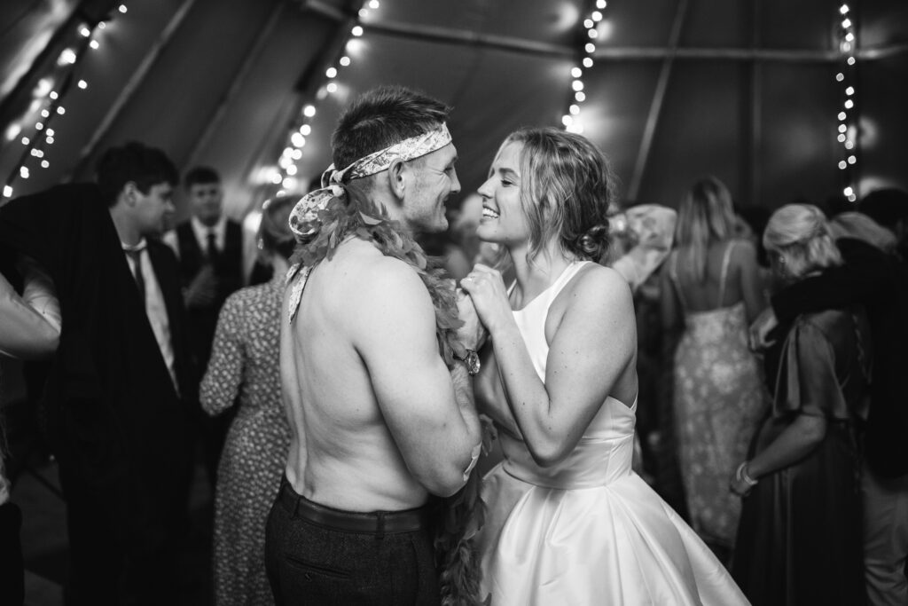 bride and groom dancing during wedding reception black and white photography Rustic farm family wedding in devon