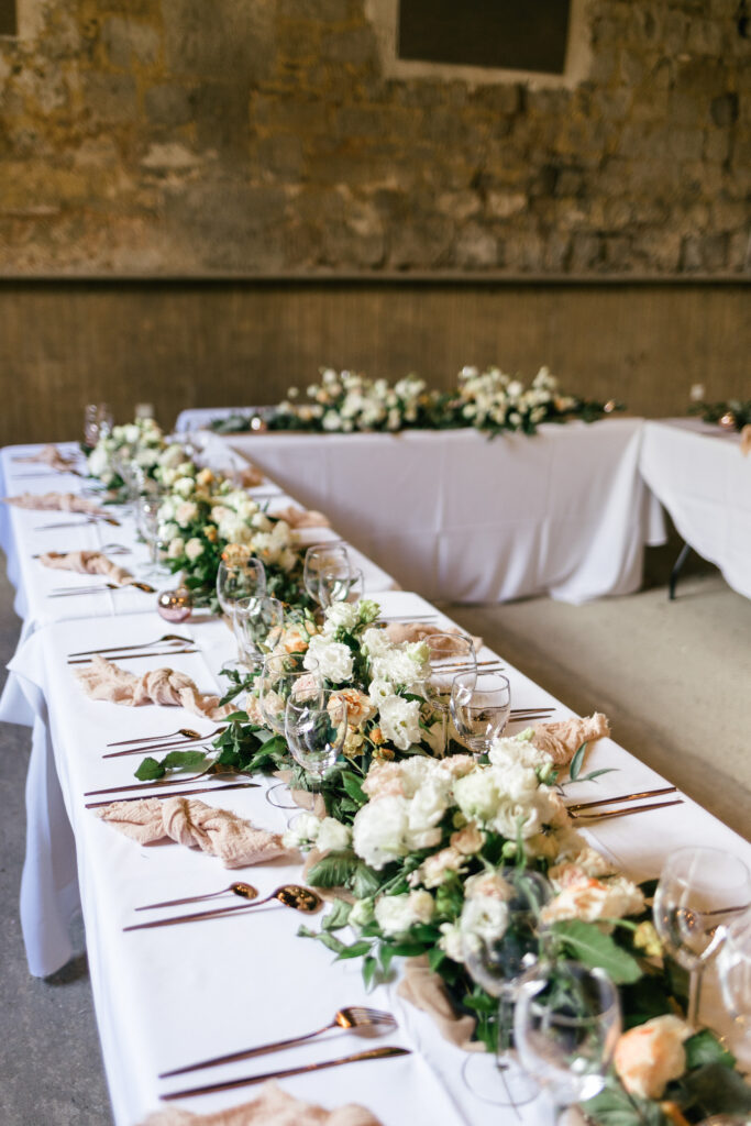 Long, rustic table decorations at French Chateau wedding photography and videography