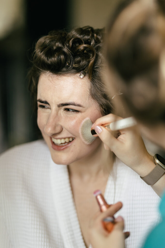 Bride having makeup on at French Chateau wedding photography and videography