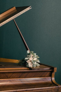 Brides flowers on a piano, detail photos of French Chateau wedding photography and videography