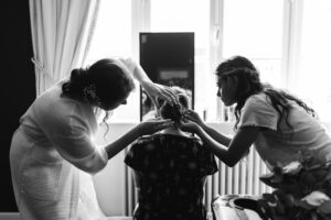 Bride's finishing touches at French Chateau wedding photography and videography