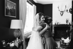 Bride hugs friend in candid moment during wedding morning