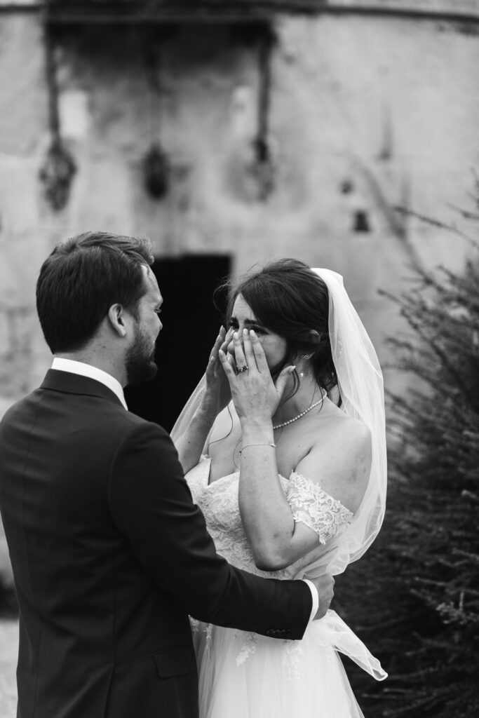 Emotional candid moment caught on camera as the bride cries after wedding ceremony