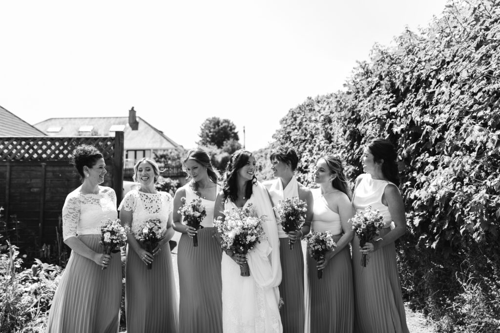 Bride poses with his bridesmaids before leaving for the church