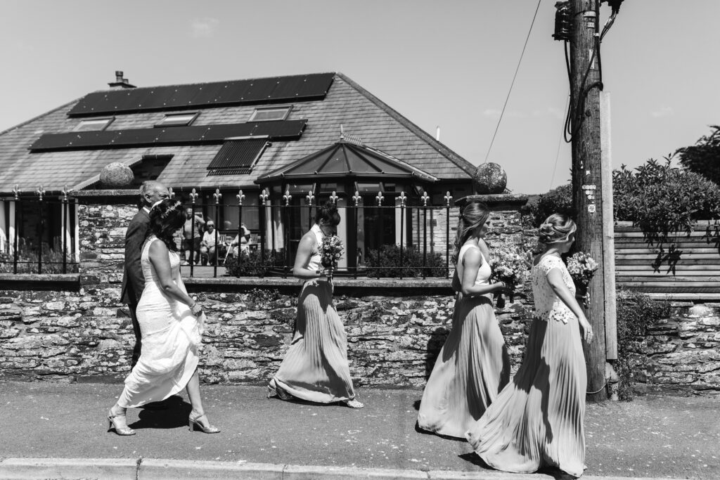 Bridesmaids walk to the church on the morning of the wedding 