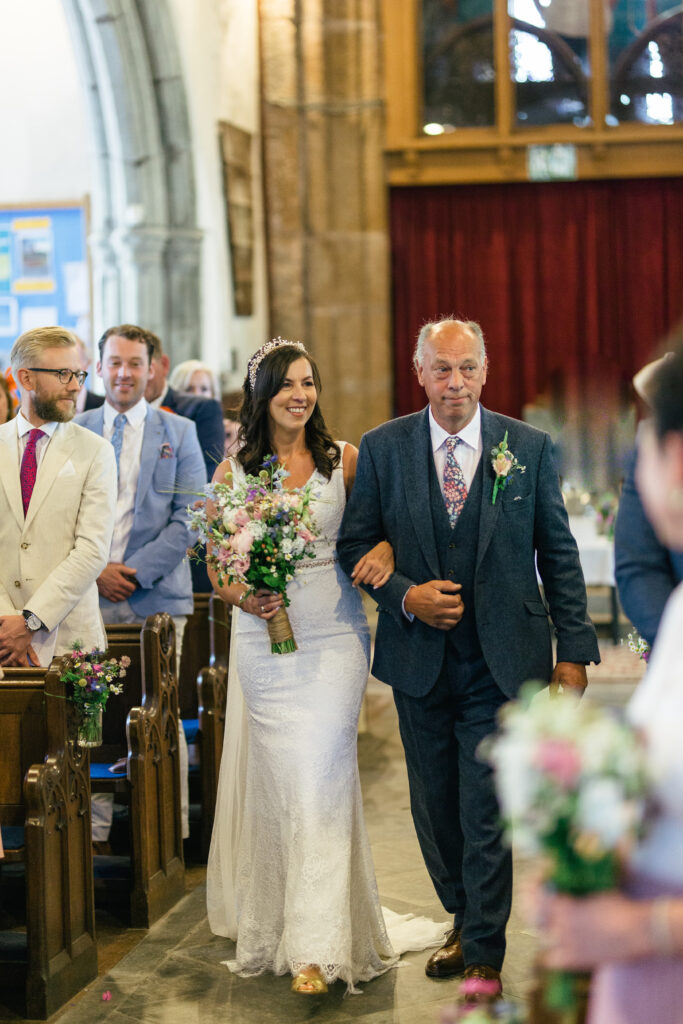 Dad walks his daughter down the isle on her wedding day, to marry in a church