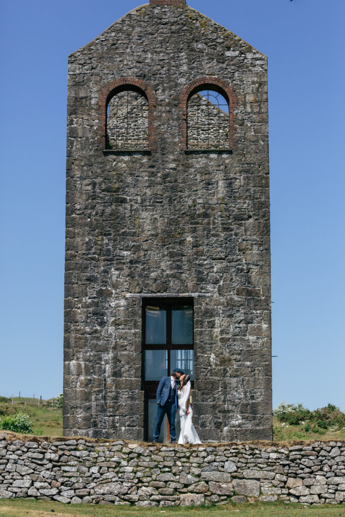 Couples photographs infront of a Cornwall mine 