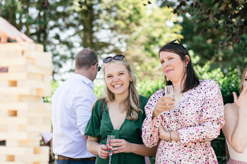 Candid photograph of a guest at wedding reception on a farm in Cornwall 