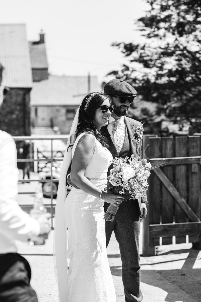 Candid photograph of Bride and Groom during their wedding reception at their family farm in Cornwall 