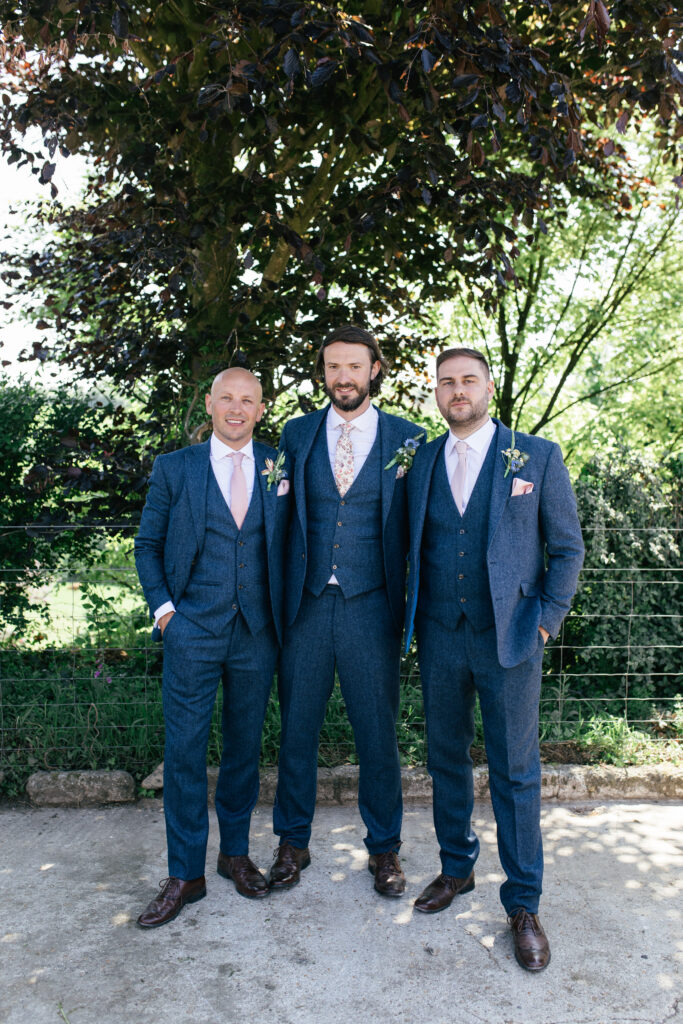 Groom poses for the camera with his best men 