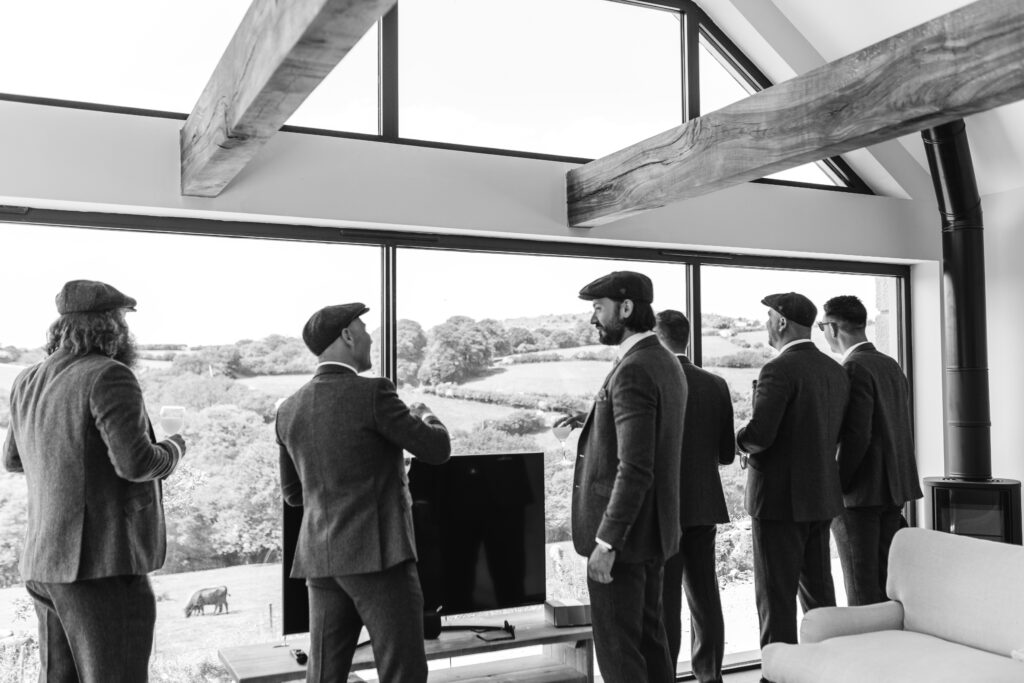 Groom and groomsmen finish getting ready in the morning