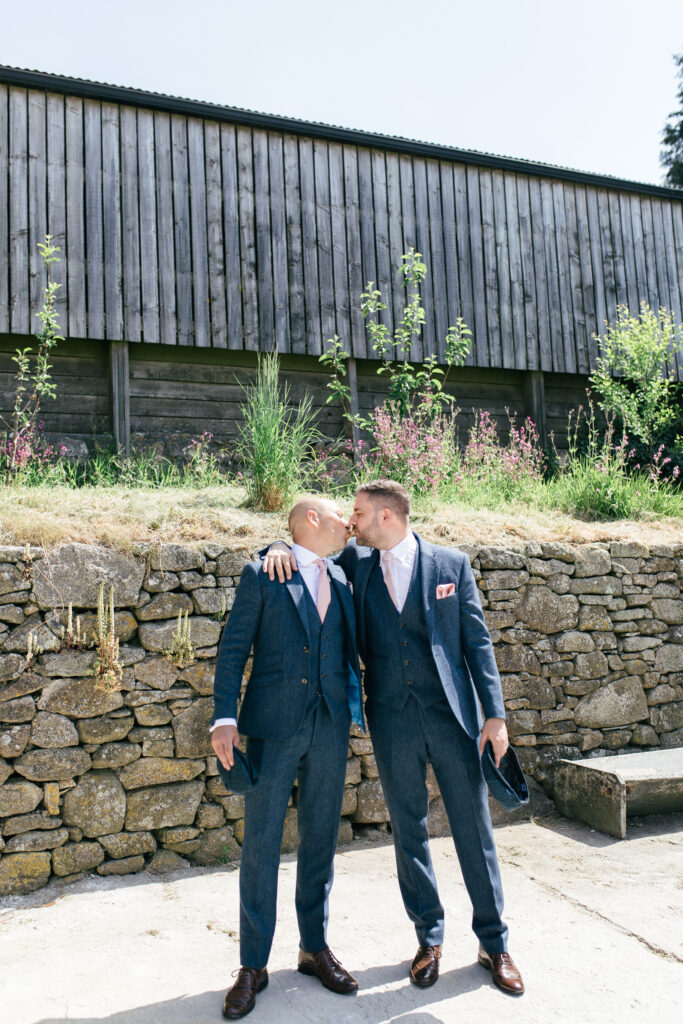 Groomsmen kiss in a funny photo on the wedding day 