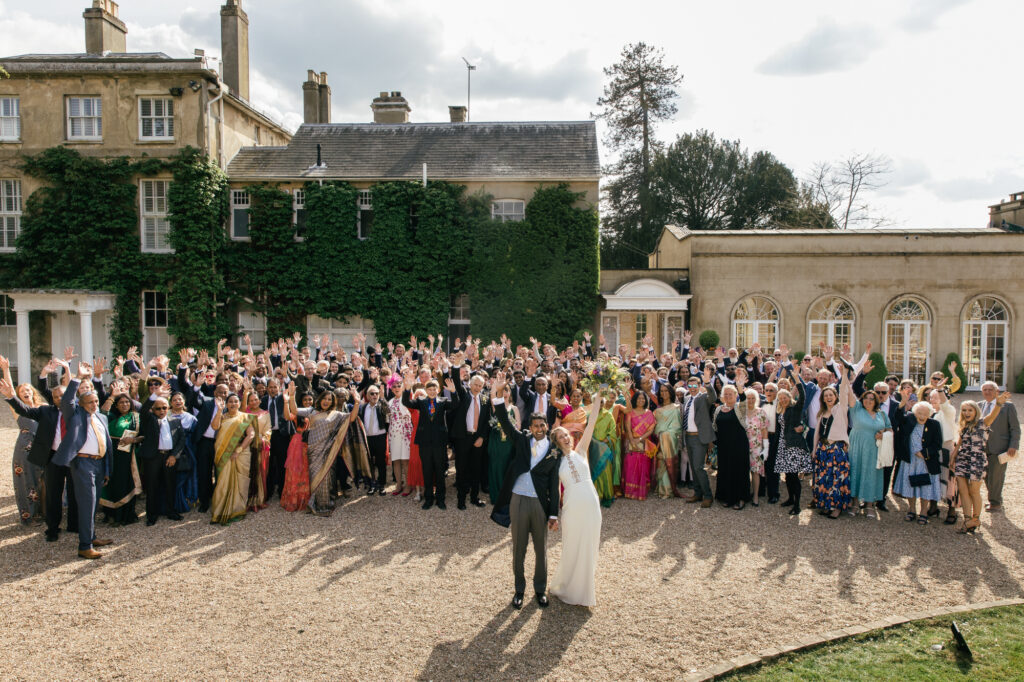 All wedding guests pose pfr photograph outside Northbrook park 