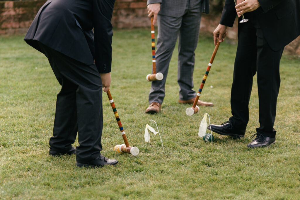 Guests play lawn games during wedding reception 