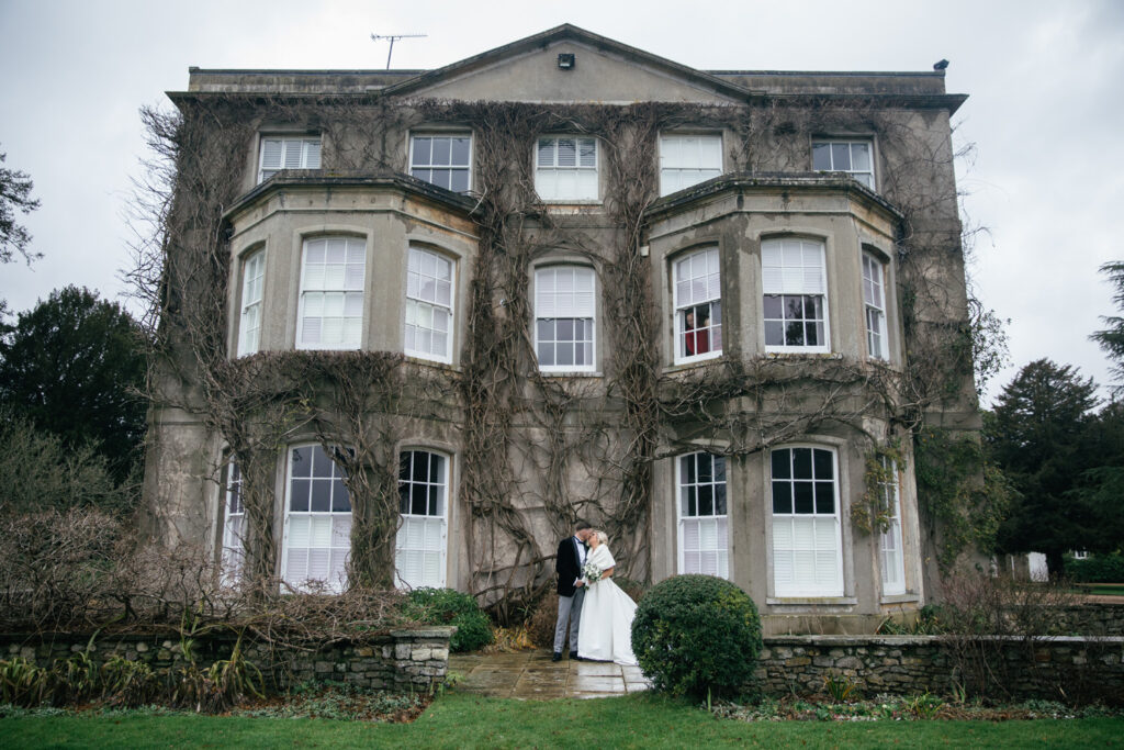 Bride and groom stand outside of wedding venue Northbrook park 