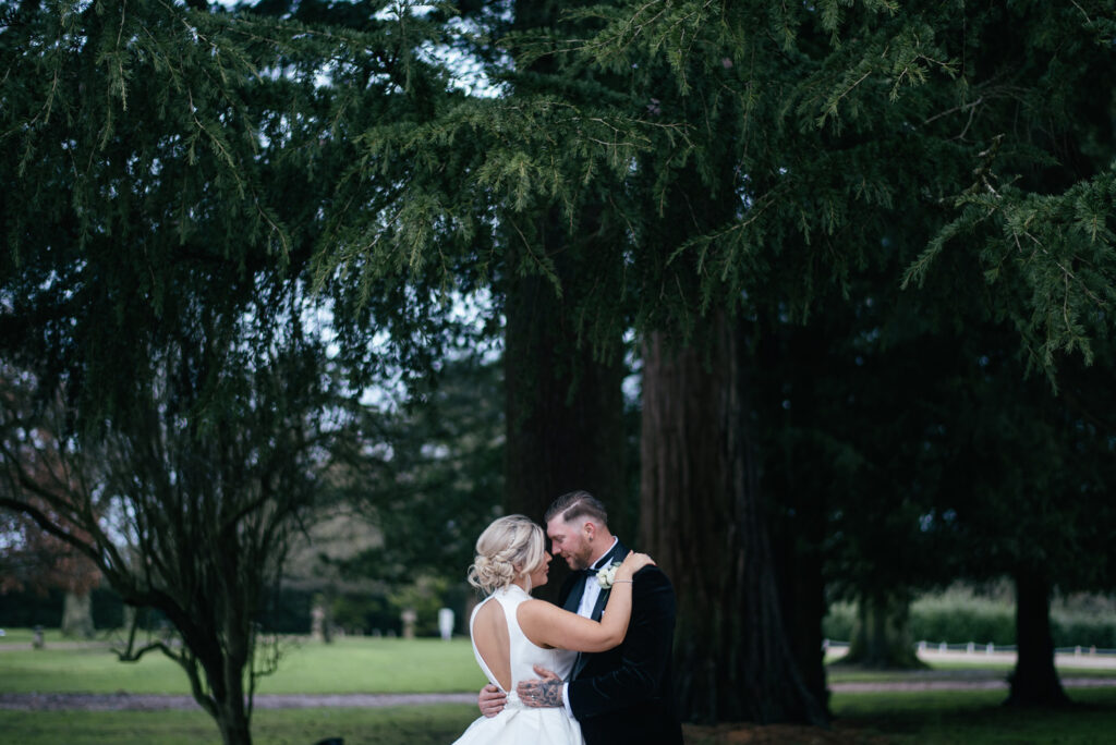 Bride and groom pose for couples photographers after the wedding 