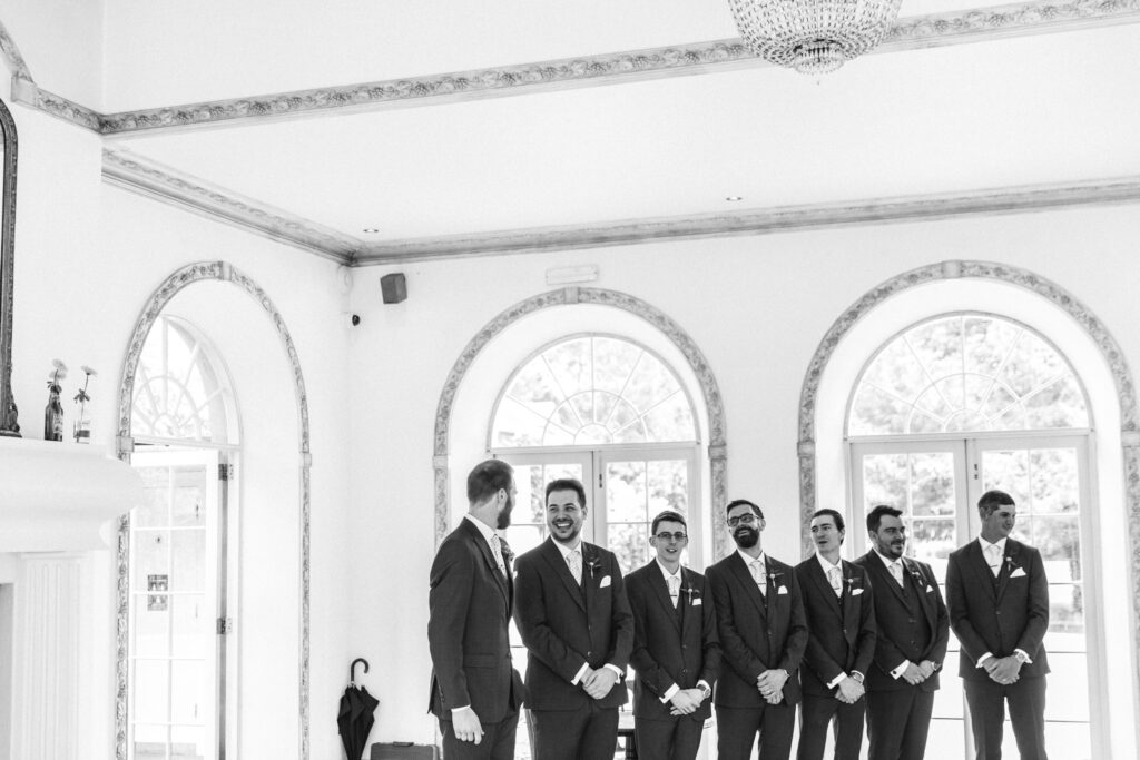 Groomsmen wait for the arrival of the bride 