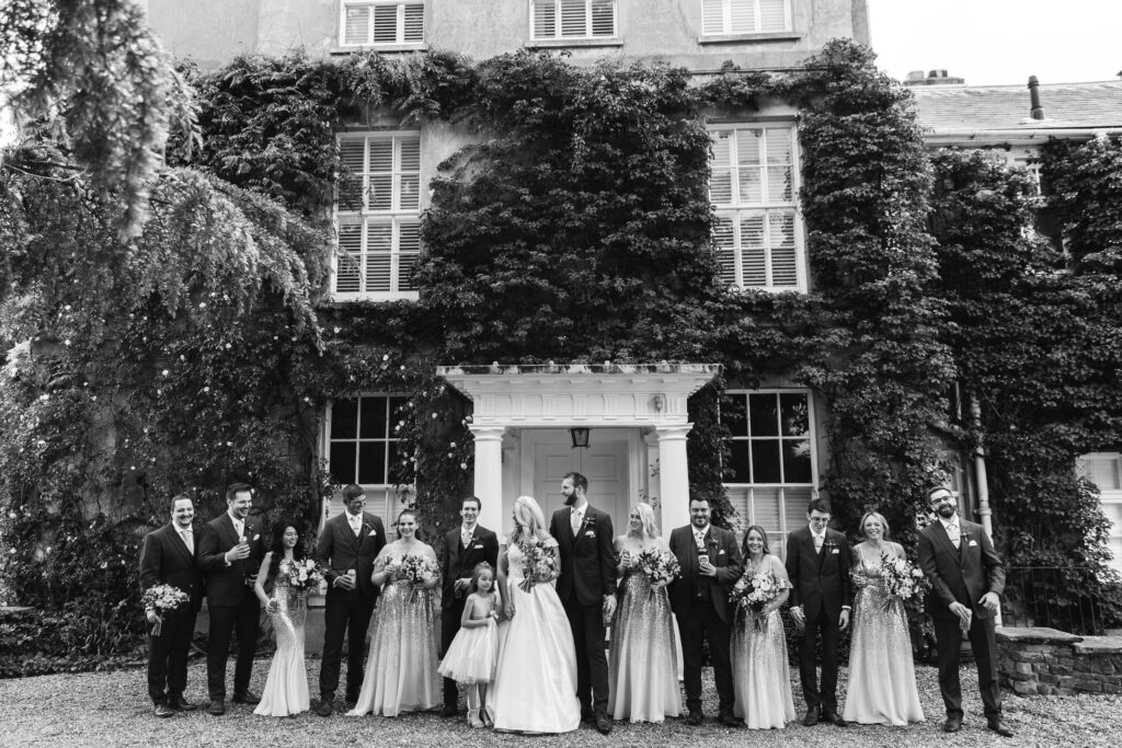 Wedding guests line up for a photograph outside Northbrook park 