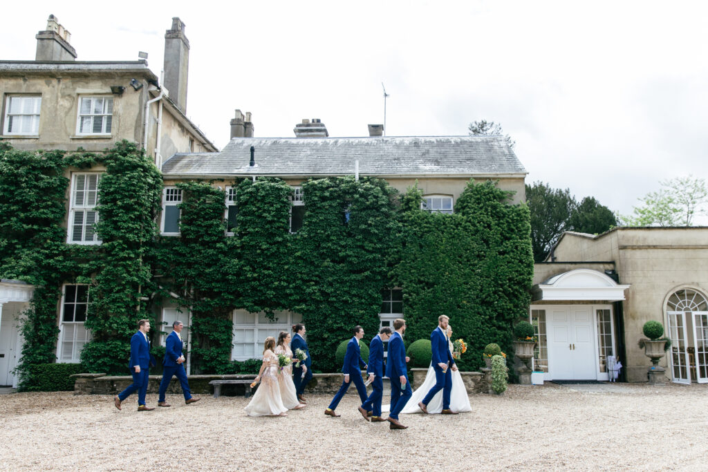 Bridal party walks together to wedding reception