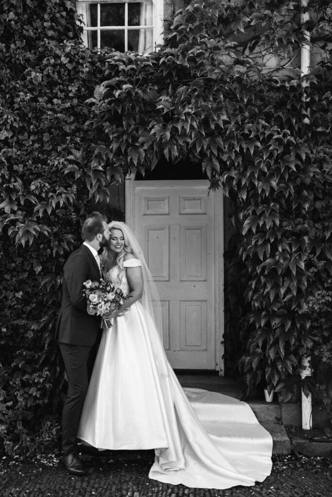 Bride and groom pose for wedding photograph