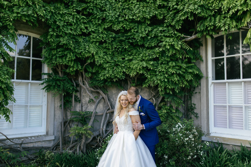 Bride and groom have a kiss and cuddle during the wedding day 