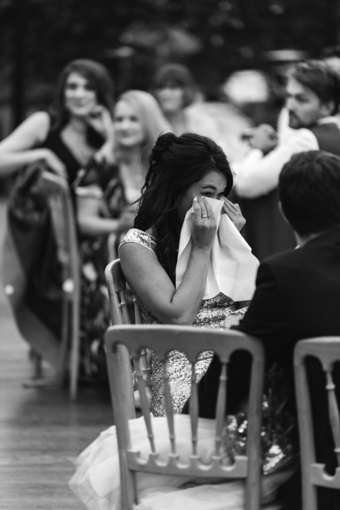 Guest blots her eyes with tissue during the speeches 