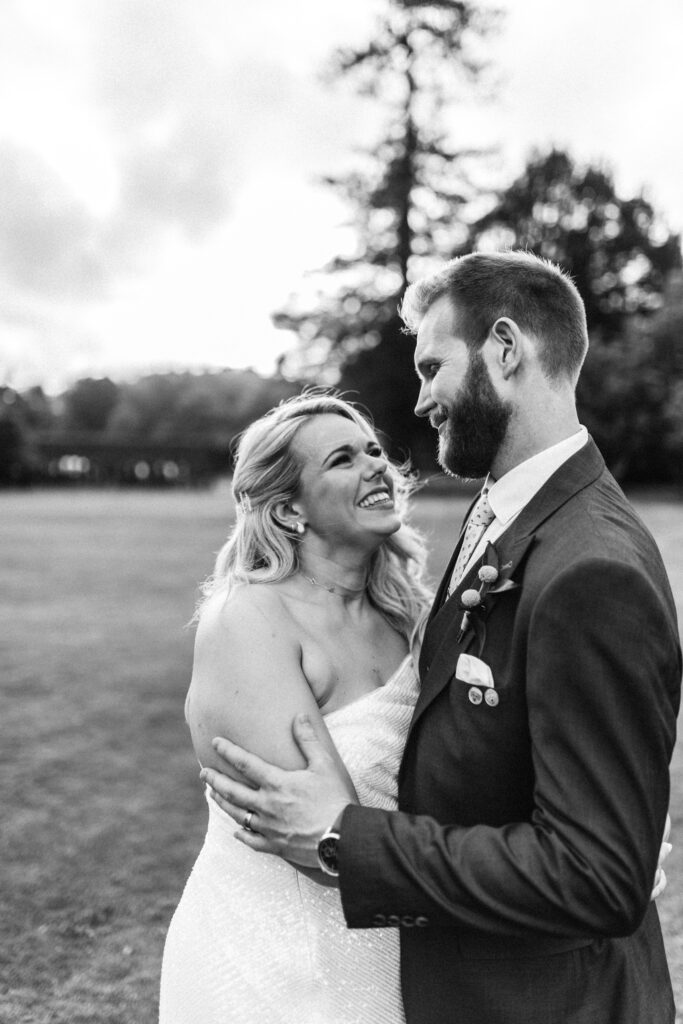 Bride and groom hold eachother and laugh