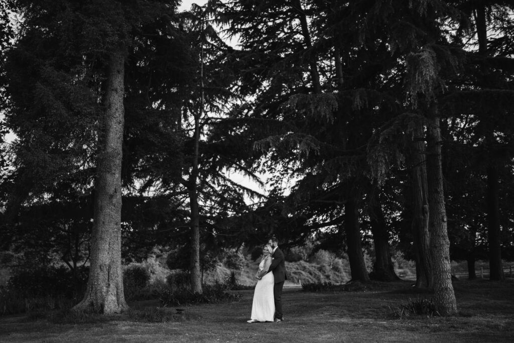 Bride and groom hug for wedding photograph