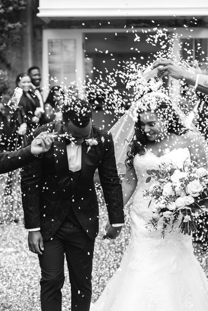 Confetti is emptied over the bride and grooms head