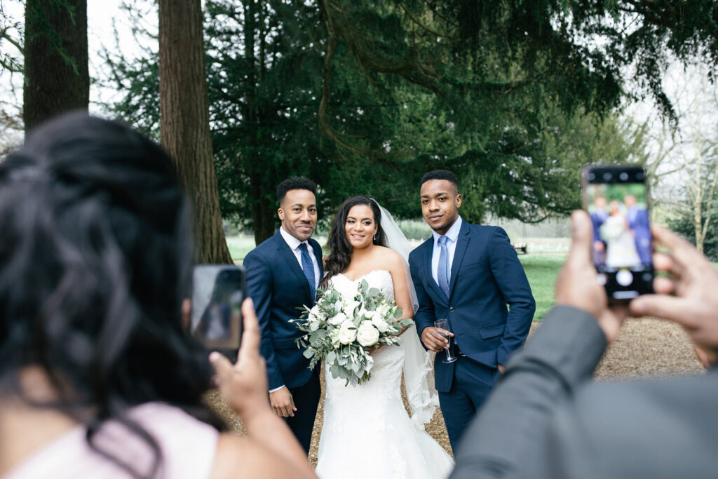 Bride and brothers pose for a photograph