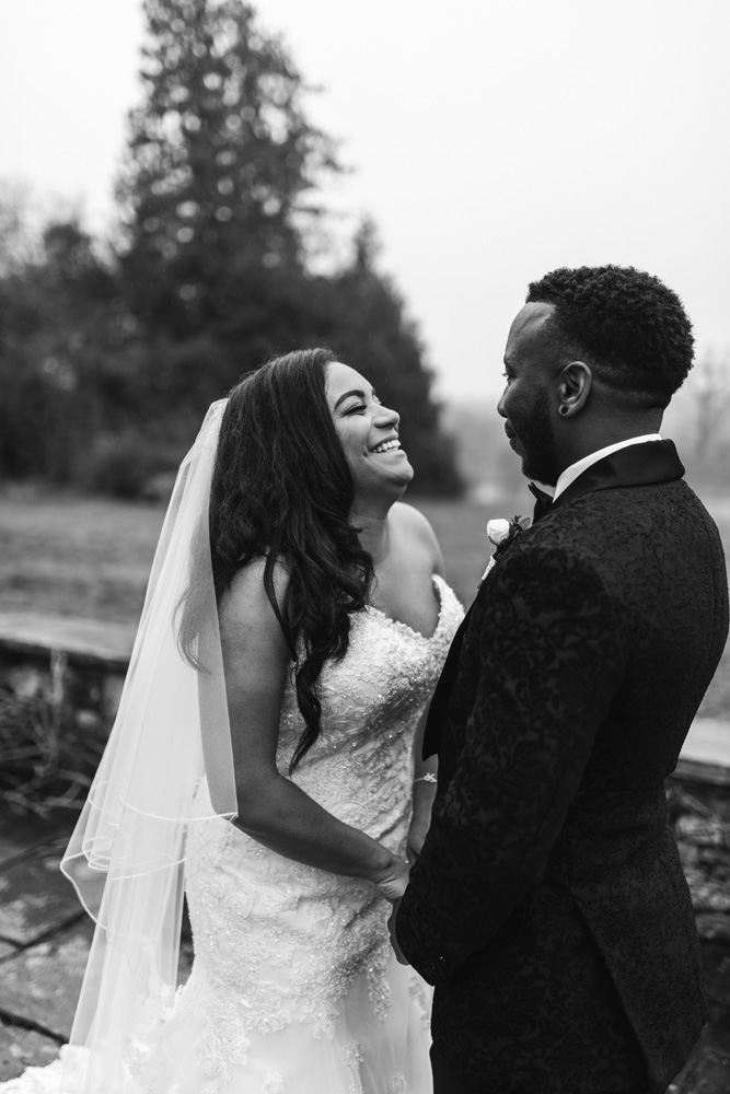 Bride laughs with groom 