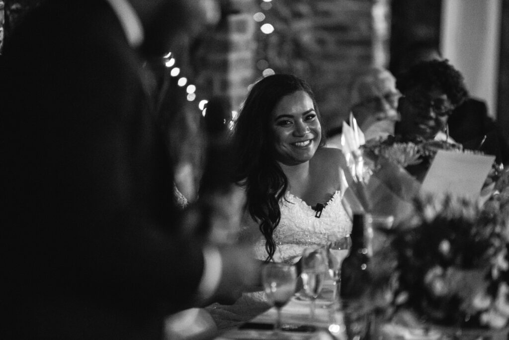 Bride smiles during speech